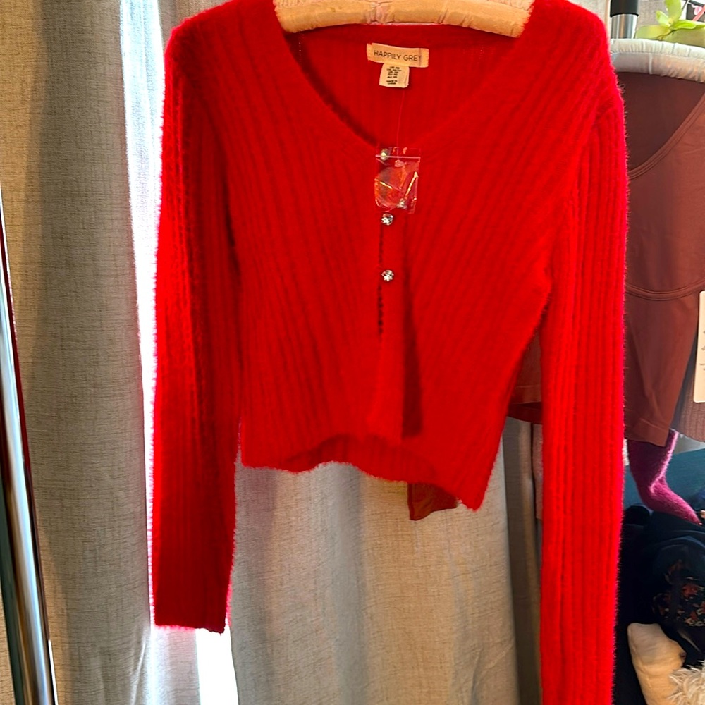 This is a red size xs sweater new with tag
